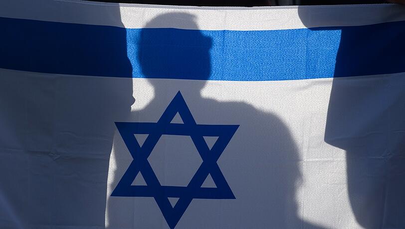 Teilnehmer einer Solidaritätskundgebung in Magdeburg schwenken eine Israel-Flagge.