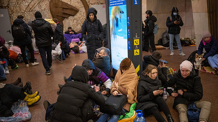 Menschen sitzen in einer U-Bahn-Station und nutzen diese als Bombenschutzraum. Russische Truppen haben ihren erwarteten Angriff auf die Ukraine gestartet.