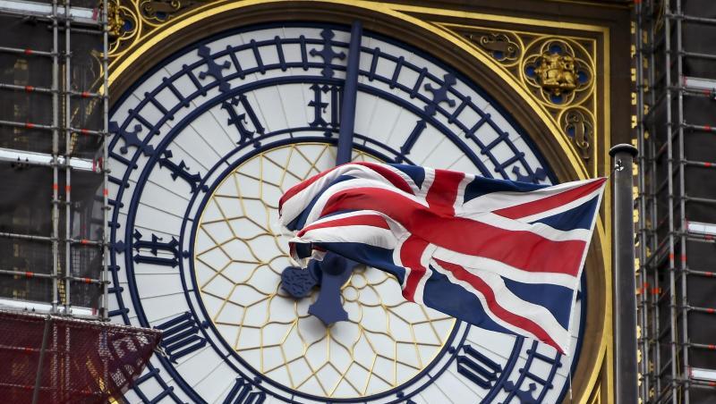 Eine am Ziffernblatt des Big Ben befestigte britische Flagge weht im Wind.