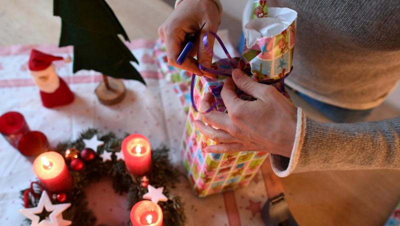 Eine Frau packt am vierten Advent Weihnachtsgeschenke ein. Eine Frau packt am vierten Advent Weihnachtsgeschenke ein.