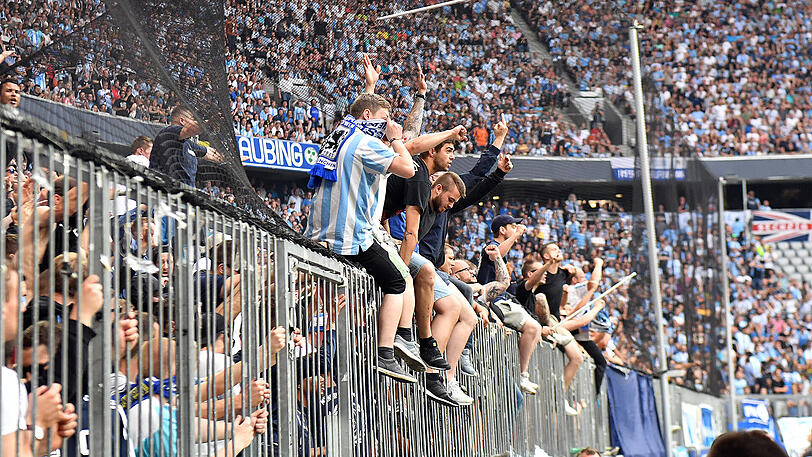 Fans des TSV 1860 München sitzen kurz vor Spielende auf dem Absperrzaun