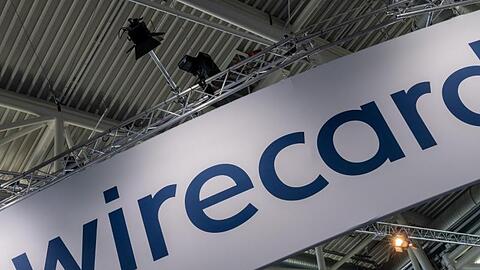 Ein Schild mit der Aufschrift "wirecard". Foto: Peter Kneffel/dpa/Archivbild