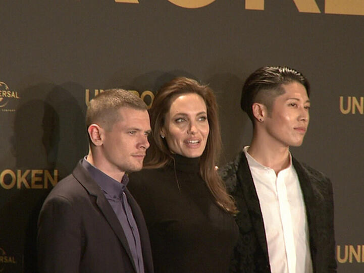Angelina Jolie (m.) zwischen zwei Darstellern aus ihrem Film "Unbroken"