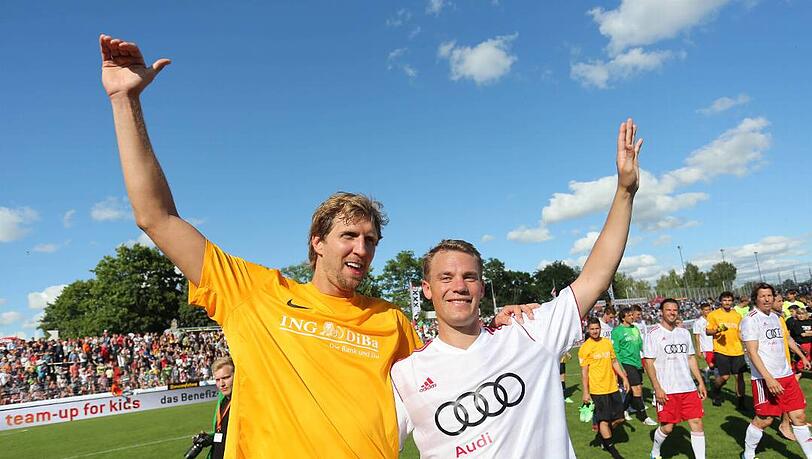 Basketballspieler Dirk Nowitzki (l.) und Fußball-Nationaltorwart Manuel Neuer bedanken sich nach dem Benefiz-Fußballspiel "Manuel Neuer & Friends - Nowitzki Allstars" in Würzburg bei den Zuschauern. Der Erlös der Veranstaltung kommt dem Projekt "Fußball trifft Kultur" der internationalen Kampagne LitCam zugute. Basketballspieler Dirk Nowitzki (l.) und Fußball-Nationaltorwart Manuel Neuer bedanken sich nach dem Benefiz-Fußballspiel "Manuel Neuer & Friends - Nowitzki Allstars" in Würzburg bei den Zuschauern. Der Erlös der Veranstaltung kommt dem Projekt "Fußball trifft Kultur" der internationalen Kampagne LitCam zugute.
