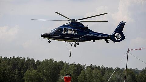 Ein Hubschrauber der Bundespolizei nimmt in Frankenförde Löschwasser auf. In Frankenförde bei Jüterbog befindet sich die Einsatzzentrale der Feuerwehr.