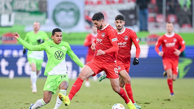 Wolfsburgs Rogerio (l) im Zweikampf mit Heidenheims Tim Kleindienst.