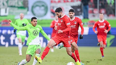 Wolfsburgs Rogerio (l) im Zweikampf mit Heidenheims Tim Kleindienst.