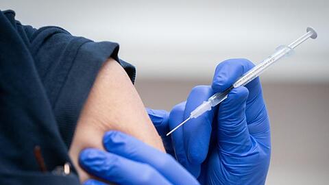 Eine Pflegekraft wird gegen das Coronavirus geimpft.