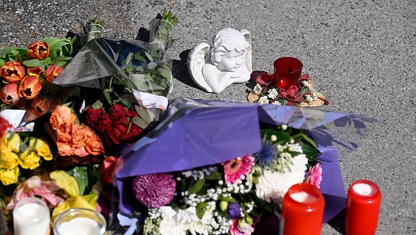 Zeichen der Anteilnahme: Auf einem Bürgersteig an dem Spielplatz sind Kerzen und Blumen niedergelegt worden.