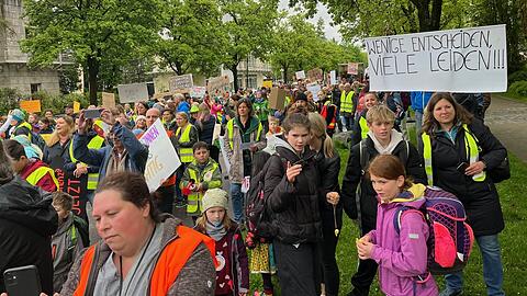 Schüler der Montessorischule demonstrieren am Freitag vor der Montessorischule mit Eltern und Lehrern.