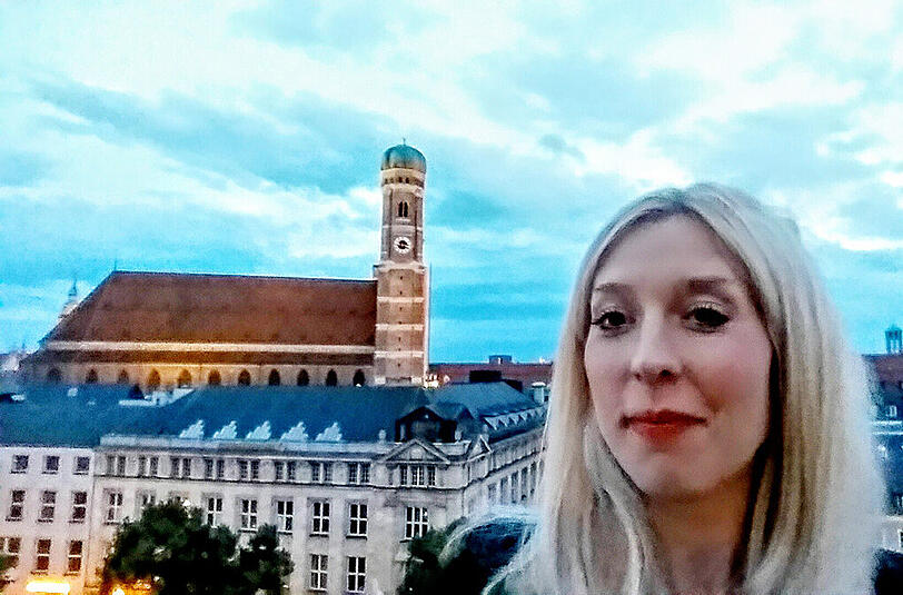 Kimberly Hoppe, LEUTE-Kolumnistin: "Selfies haben eine eigene Magie, meist schaut man ziemlich deppert aus, aber das macht es ja gerade charmant. In meinem Alltag sind viele Selfie-verrückt. Promis wie Elyas M&rsquo;Barek, die wissen, dass die Fans eh nur ihr Idol in XL sehen wollen. Aber auch viele Freundinnen von mir schicken gern Selfies &ndash; als Zwischendurch-Gruß wie eine schnellere und persönlichere Postkarte. Ich habe das Selfie auf der Dachterrasse vom Bayerischen Hof gemacht &ndash; da kann übrigens jede(r) hoch! Ich liebe die Frauenkirche, vor allem, wenn sie nachts angestrahlt wird. Das Selfie ist in der Dämmerung entstanden, weshalb ich es aufhellen musste. Aber: psst!"