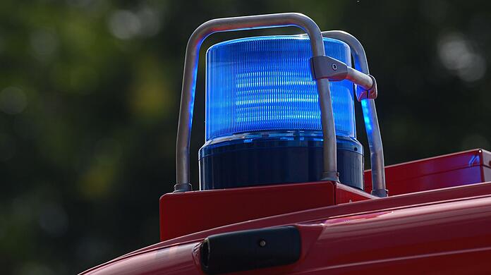 Ein Blaulicht leuchtet auf dem Dach eines Einsatzfahrzeugs der Feuerwehr.