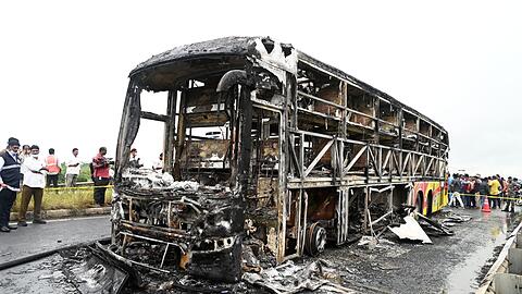 Die verkohlten Überreste des Passagierbusses liegen auf einer Landstraße im Dorf Chinnatekuru.
