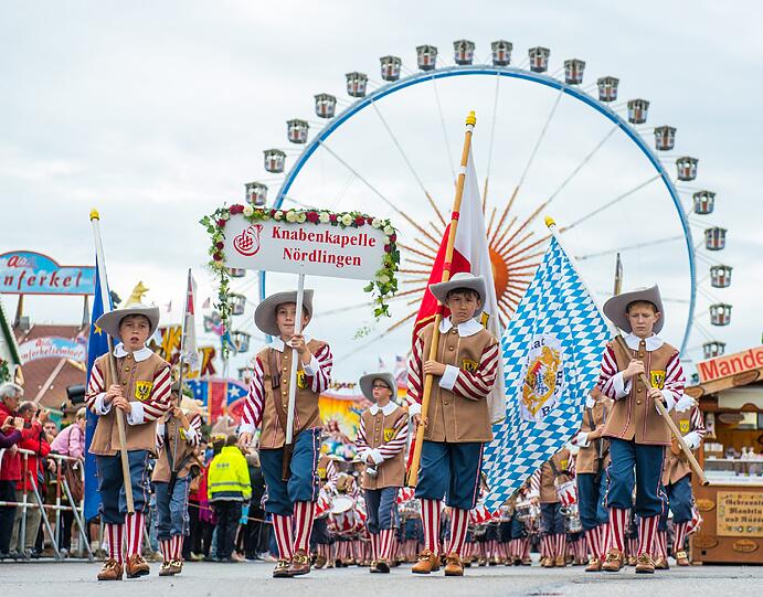 Trotz Nieselwetters rollten rund 40 Festwagen und Kutschen in dem sieben Kilometer langen Zug mit - und die Trachtler aus der ganzen Welt hatten dabei beste Laune.