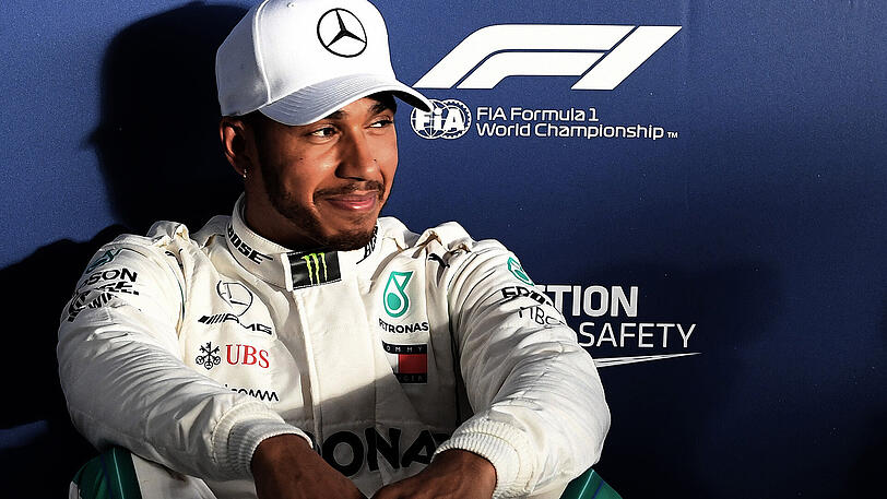 Lewis Hamilton kann strahlen: Nach dem Qualifying sitzt der Brite auf dem Boden vor den Pressevertretern.
