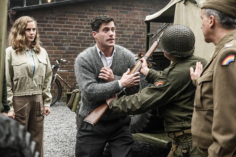 Als die Amerikaner Ende des Zweiten Weltkriegs ins Fränkische einmarschieren, soll die Dassler-Fabrik gesprengt werden. Käthe (Picco von Groote) und Adi Dassler (Ken Duken, zweiter von links) können den US-Colonel (Christopher Buchholz) überzeugen, die Werkhalle stehen zu lassen. Als die Amerikaner Ende des Zweiten Weltkriegs ins Fränkische einmarschieren, soll die Dassler-Fabrik gesprengt werden. Käthe (Picco von Groote) und Adi Dassler (Ken Duken, zweiter von links) können den US-Colonel (Christopher Buchholz) überzeugen, die Werkhalle stehen zu lassen.