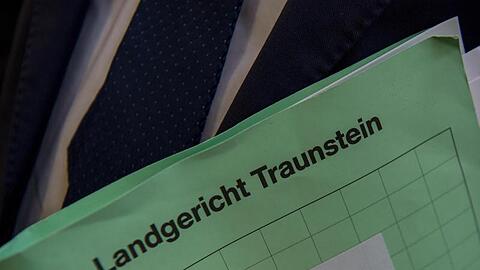 Ein Mann im Landgericht Traunstein eine Mappe mit der Aufschrift "Landgericht Traunstein". Foto: Peter Kneffel/dpa