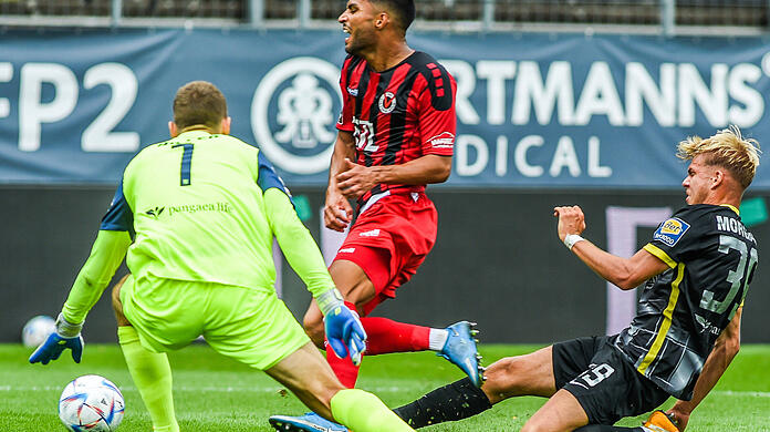 Leandro Morgalla verursacht im Duell mit Simon Stehle den Elfmeter, der zum 1:0 von Viktoria Köln führt, Links 1860-Keeper Marco Hiller.