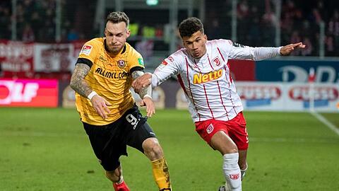 Patrick Schmidt von Dynamo Dresden (l.) und Chima Sean Okoroji von Regensburg im Zweikampf. Foto: Matthias Balk/dpa