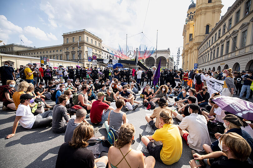 Aktivisten demonstrieren mit einer Sitzblockade am Odeonsplatz.