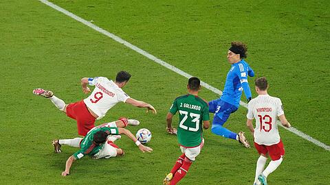 Robert Lewandowski (l) von Polen wird vom Mexikaner Hector Moreno (2.v.l) im Strafraum gefoult. Den anschließenden Elfmeter kann der Pole nicht verwandeln.