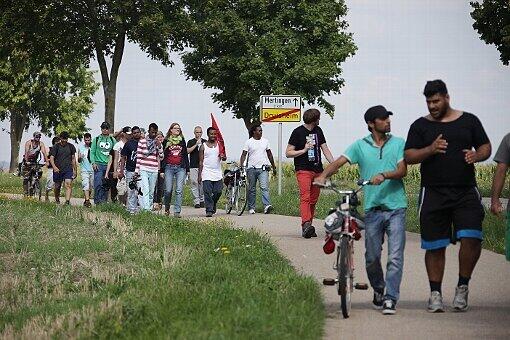 Zwei Flüchtlinge gehen immer voraus - sie haben Fahrräder mit dabei.
