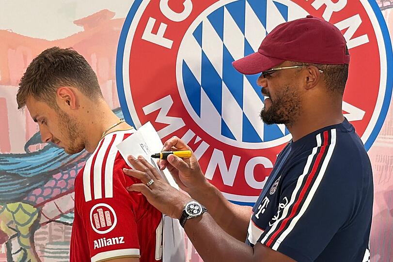 Trainer Vincent Kompany (r) malt - und Josip Stanisic muss raten. Trainer Vincent Kompany (r) malt - und Josip Stanisic muss raten.