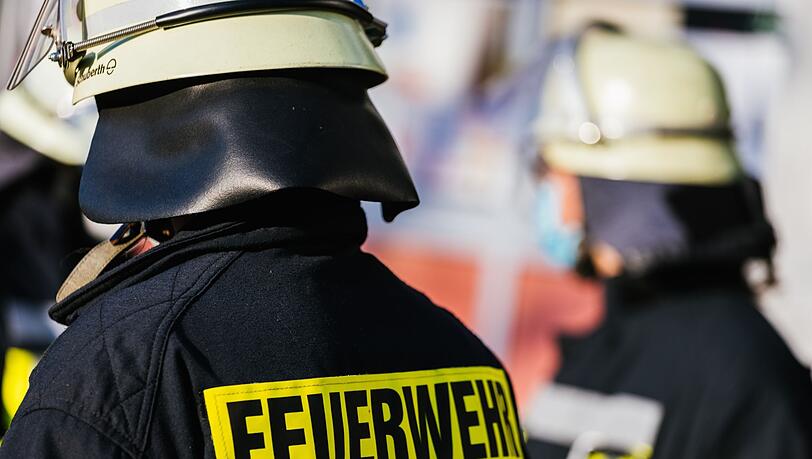 Einsatzkräfte der Feuerwehr in Schutzkleidung.