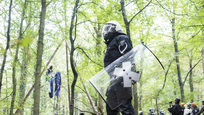 Polizisten stehen im September 2018 vor einer Barrikade im Hambacher Forst, in der sich eine Aktivistin festgebunden hat.