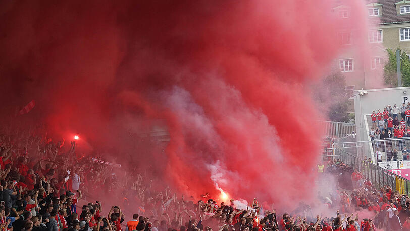 Die Bayern-Tribüne wird eingenebelt von dichtem Qualm. Fans brennen Feuerwerk ab und entzünden bengalische Feuer. Die Bayern-Tribüne wird eingenebelt von dichtem Qualm. Fans brennen Feuerwerk ab und entzünden bengalische Feuer.