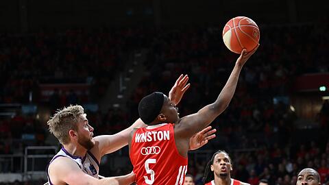 Bayerns Cassius Winston (M) und Göttingens Till Pape (l) in Aktion.