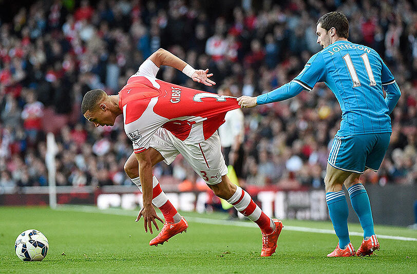 Kieran Gibbs (links) versucht sich aus der Umklammerung von Sunderlands Adam Johnson zu entziehen.