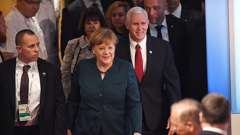Bundeskanzlerin Angela Merkel (CDU) und US-Vizepräsident Mike Pence (r.) betreten am Samstagmorgen den Konferenzsaal im Bayerischen Hof.