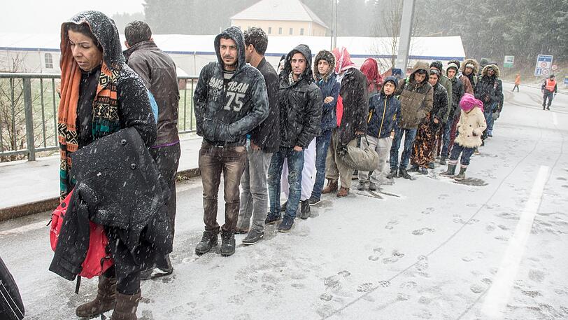 Flüchtlinge warten im Dezember 2015 an der deutsch-österreichischen Grenze nahe Wegscheid (Bayern) während eines Schneeschauers auf ihre Einreise nach Deutschland.