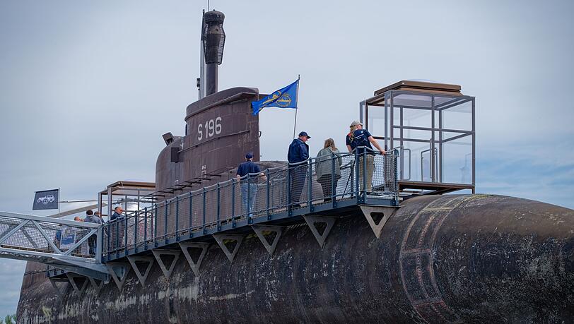 Besucher gehen über einen Steg am Marine U-Boot U17 entlang.