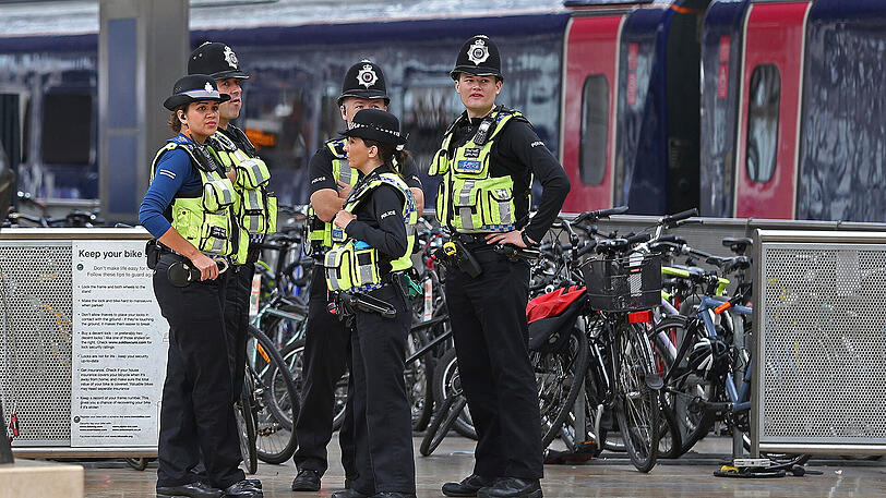 Polizisten stehen in London an einem Bahnsteig - am Samstag gab es eine erste Festnahme.