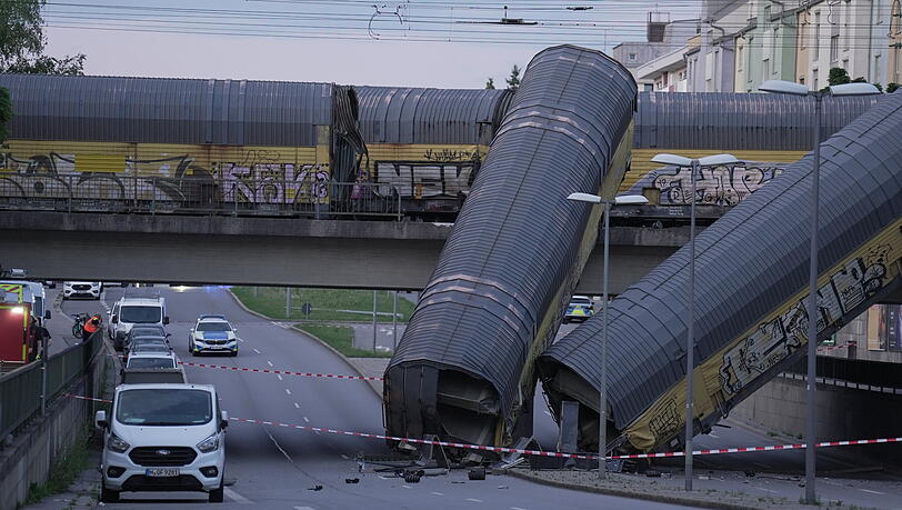 Zwei Waggons eines Güterzugs liegen auf der Schleißheimer Straße Straße, nachdem sie von einer Brücke gestürzt sind. Zwei Waggons eines Güterzugs liegen auf der Schleißheimer Straße Straße, nachdem sie von einer Brücke gestürzt sind.