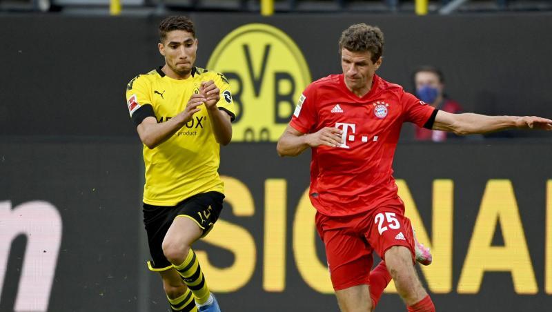 Dortmunds Achraf Hakimi und Münchens Thomas Müller (l-r.) in Aktion. Foto: Federico Gambarini/dpa-Pool/dpa Dortmunds Achraf Hakimi und Münchens Thomas Müller (l-r.) in Aktion. Foto: Federico Gambarini/dpa-Pool/dpa