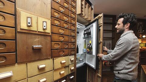 Der Kühlschrank, den Urs Jahn öffnet, ist im alten Apotheken-Inventar versteckt.