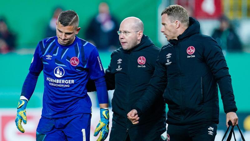 Nürnbergs Torwart Patric Klandt (l) verlässt verletzt das Spielfeld. Foto: Uwe Anspach/dpa Nürnbergs Torwart Patric Klandt (l) verlässt verletzt das Spielfeld. Foto: Uwe Anspach/dpa
