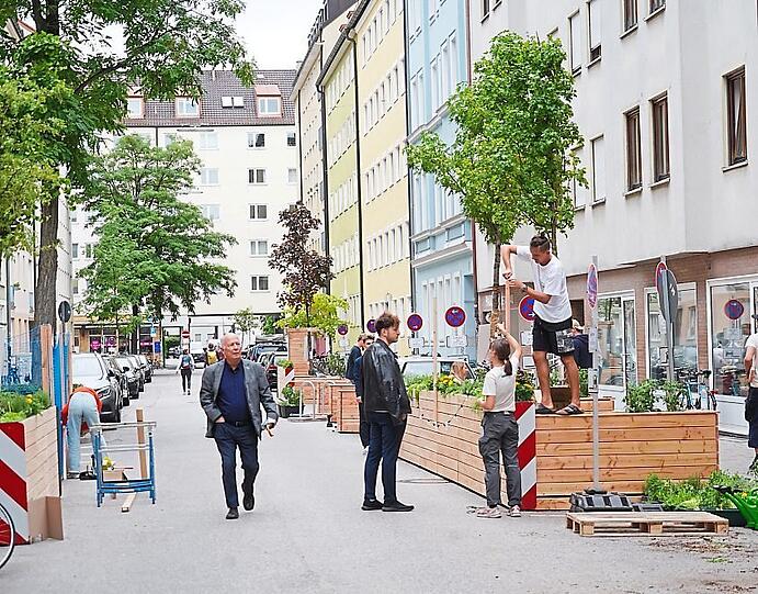 Etwa 40 junge Menschen sind am Tag vor der Einweihung der neu gestalteten Straße hier beschäftigt.
