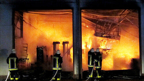 Aus den ehemals wertvollen Omnibussen machten die Flammen im Inneren der Halle nur glühende Eisenskelette. Aus den ehemals wertvollen Omnibussen machten die Flammen im Inneren der Halle nur glühende Eisenskelette.
