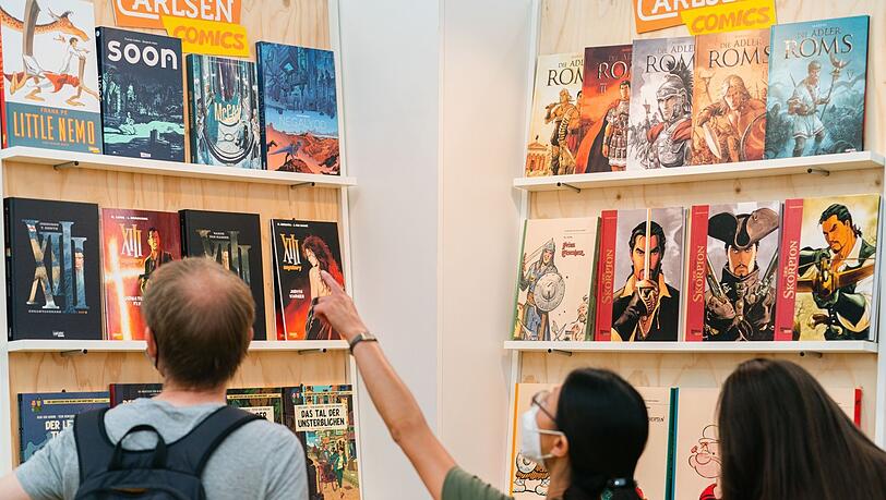 Besucher stehen in einer Halle auf dem Comic-Salon 2022 in Erlangen. Besucher stehen in einer Halle auf dem Comic-Salon 2022 in Erlangen.