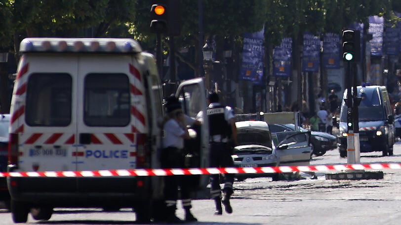 Polizisten blockieren die Zufahrt zu den Champs Elysees in Paris. Ein Mann war mit seinem Auto auf ein Fahrzeug der Gendarmerie geprallt.