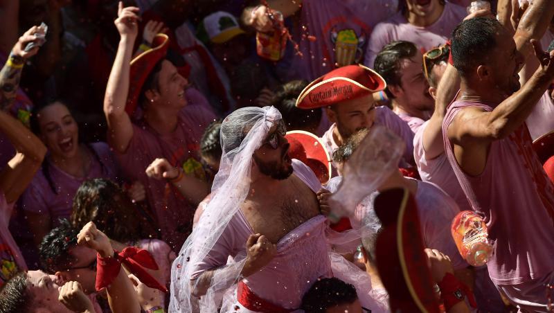 Weiß-Rot gekleidete Menschen feiern zu Beginn des "Sanfermines"-Festes, während sie auf das Abfeuern der Eröffnungsrakete "Chupinazo" warten. Weiß-Rot gekleidete Menschen feiern zu Beginn des "Sanfermines"-Festes, während sie auf das Abfeuern der Eröffnungsrakete "Chupinazo" warten.
