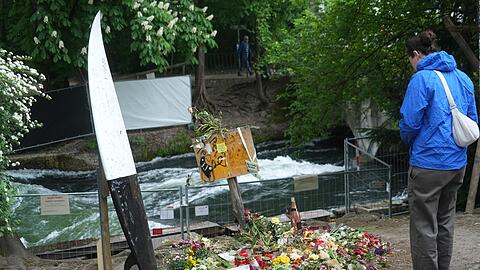 Die Anteilnahme ist groß: Viele Menschen haben an der Unglücksstelle an der Eisbachwelle Blumen und Kerzen abgelegt.