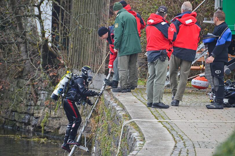 Ein eisiger Einsatz: Der Polizeitaucher steigt aus dem Tegernsee, Kollegen nehmen ihn in Empfang.