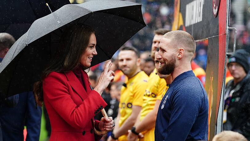 Princess Kate cheers on the England rugby team in the rain