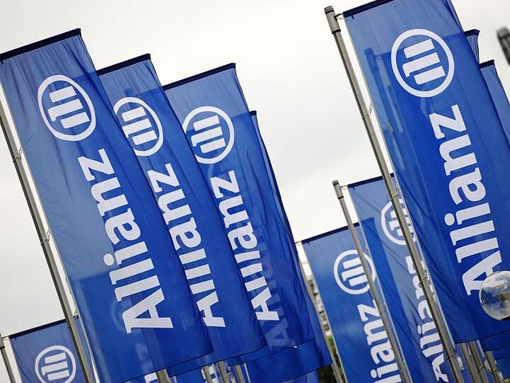 Fahnen mit dem Logo der Allianz wehen im Wind. Foto: Andreas Gebert/dpa/Archivbild