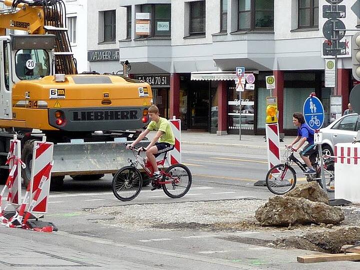 Weil hier die Fahrbahn erneuert wird, heißt es für Radler: Slalomfahren um Warnschilder, aufgerissenen Asphalt und Baumaschinen.